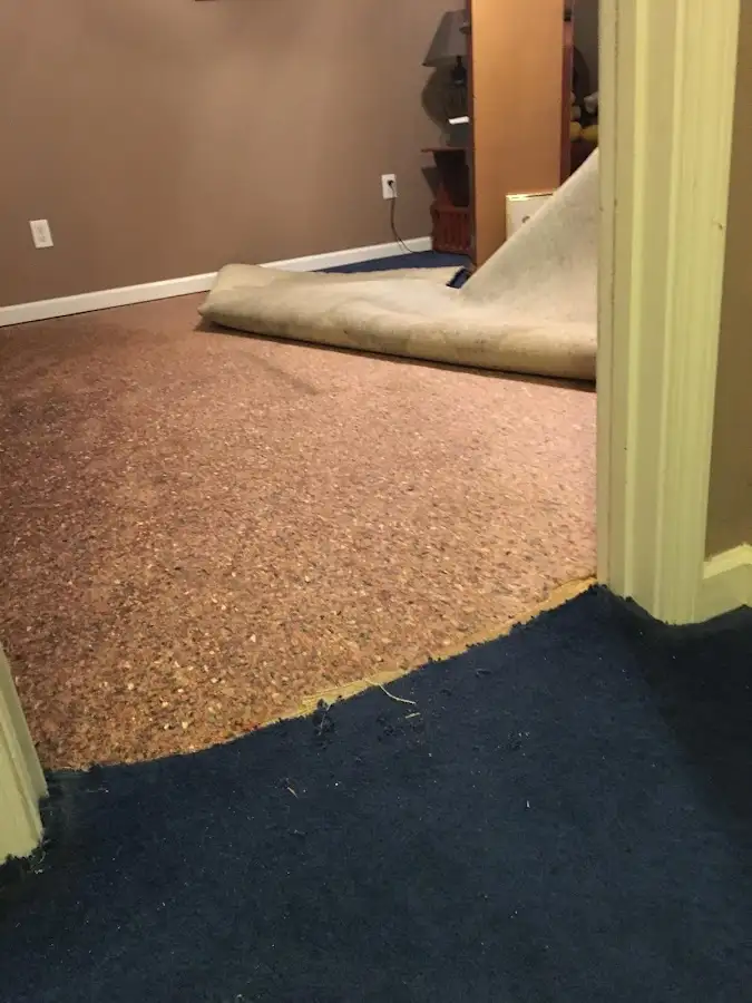 Carpet pad removal revealing water damage during Water Mitigation Services in Kaneohe Base
