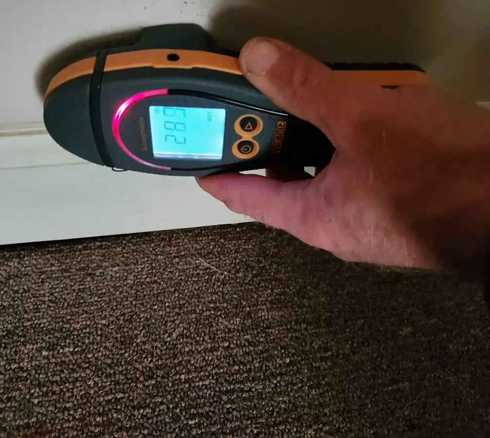 Moisture detection at baseboard during Burst Pipe Cleanup in Kaneohe Base